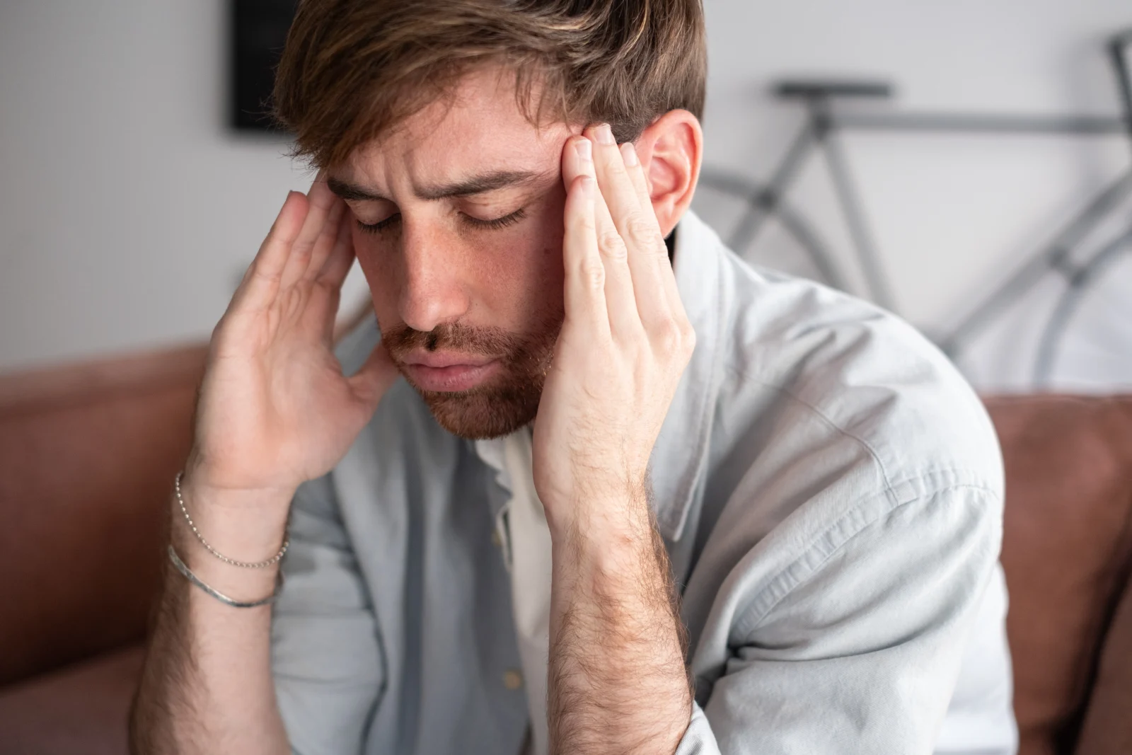 Man holding his head, stressed – online psychiatry in Everett, WA
